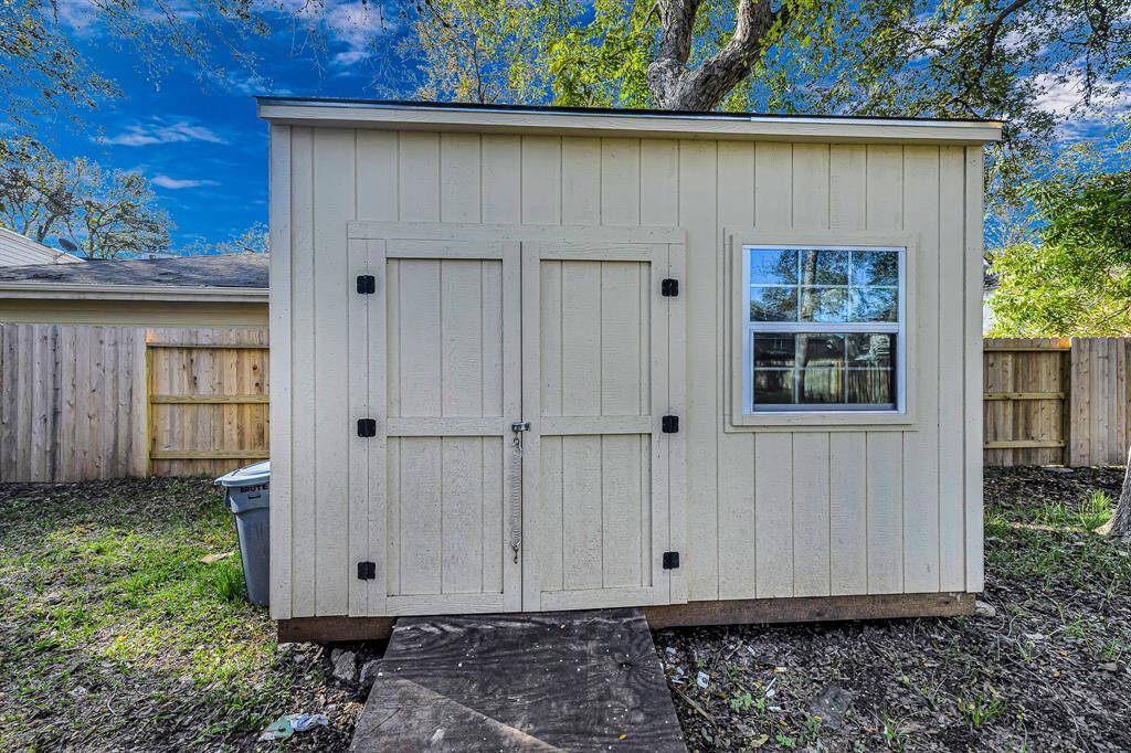 The backyard also has a NEW and spacious storage shed!