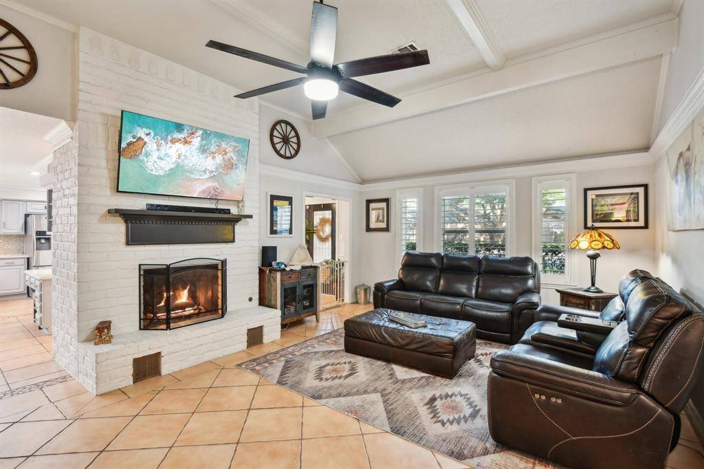 Family features tile flooring, gas log fireplace, plantation shutters & wet bar
