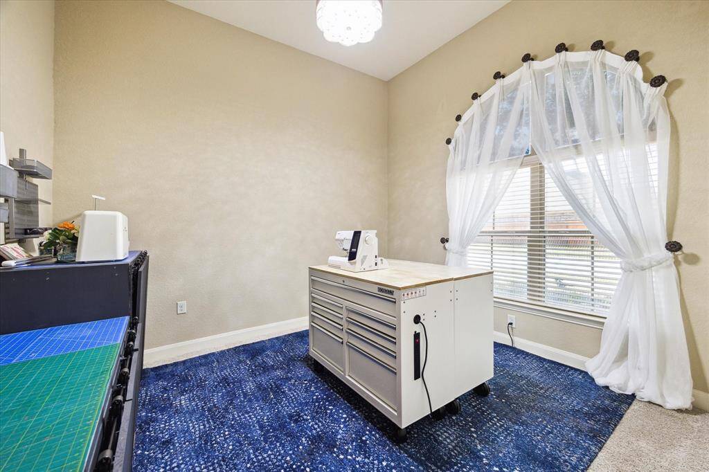 High ceilings in this spacious secondary bedroom, that is being used as a craft room currently.