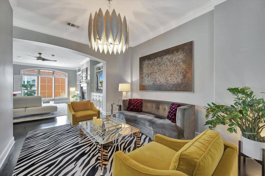 The formal dining room is currently used as a serene sitting area, offering a tranquil lounge space ideal for intimate conversations.