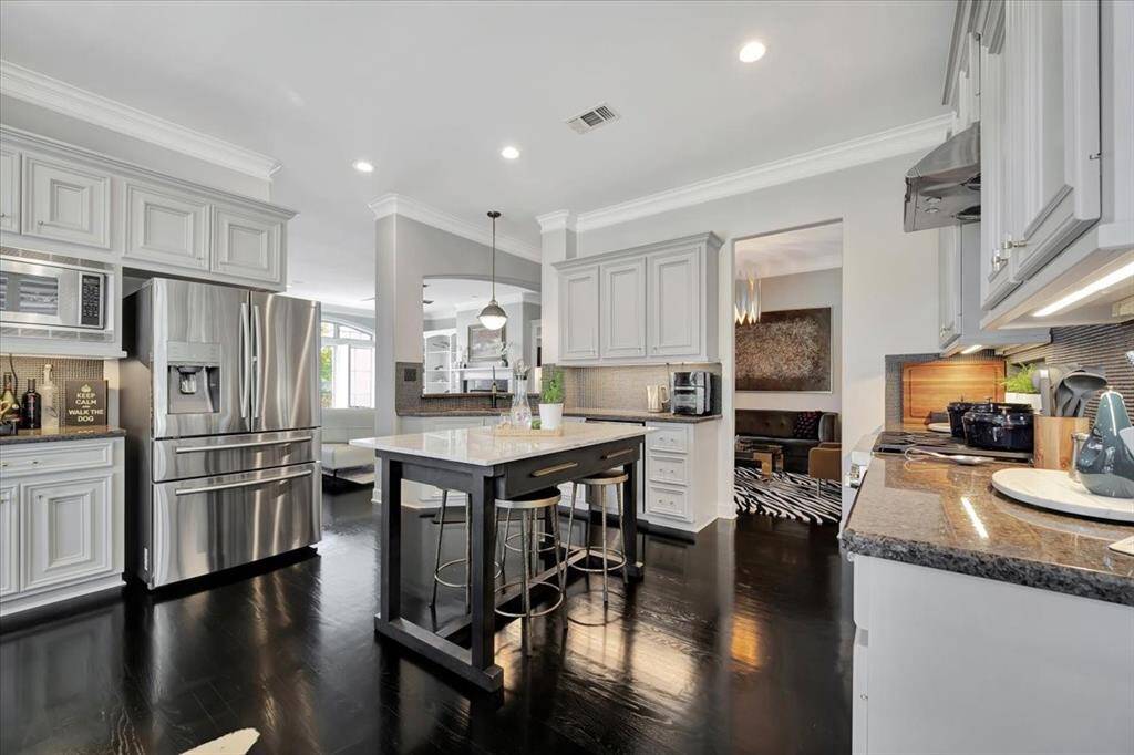 This kitchen is spacious with lots of cabinetry and an island provides extra seating.