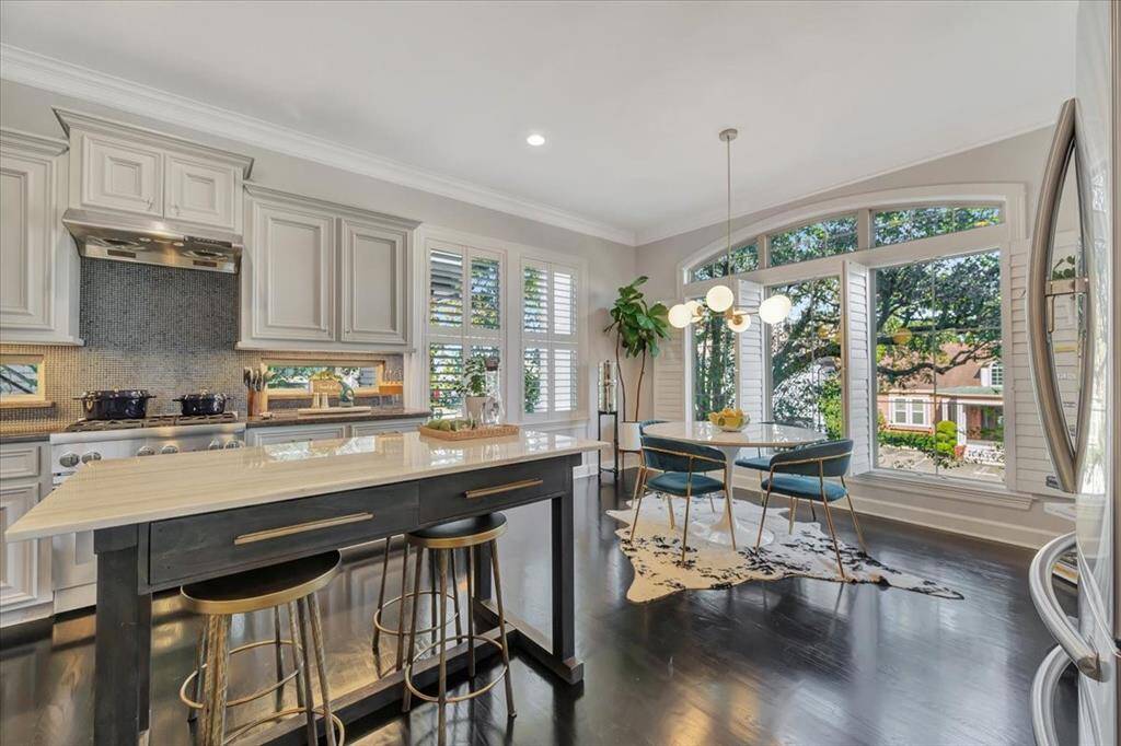 Abundant natural light fills the kitchen, and with the added center island, it becomes the perfect gathering place for toasting and conversations.