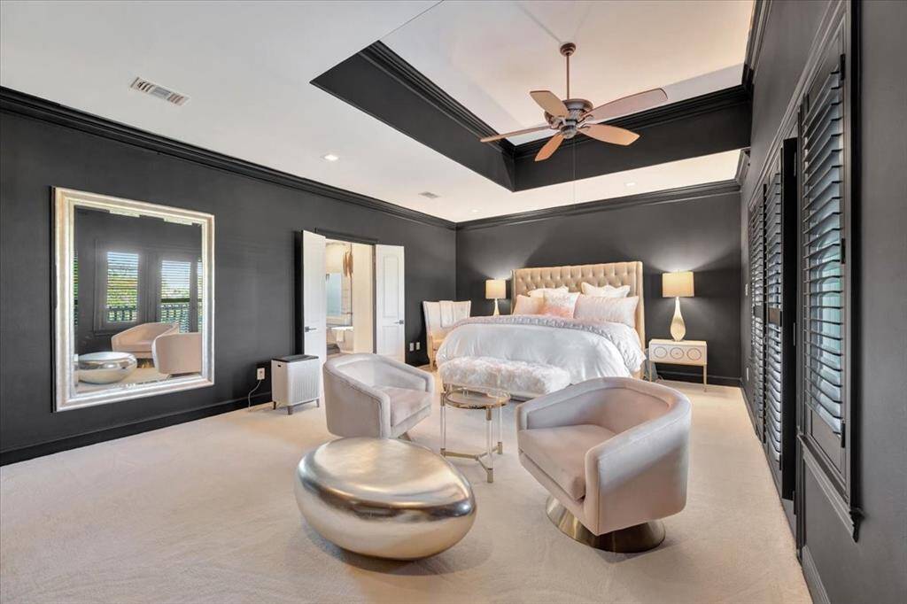 You'll fall in love the moment you enter this primary suite, where pristine white carpet and bold, dramatic walls set the tone for timeless elegance.
