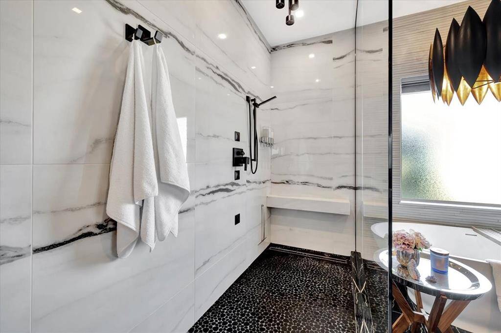 Designer selected high end porcelain tile in White Fantasy were used for this spacious walk in shower.