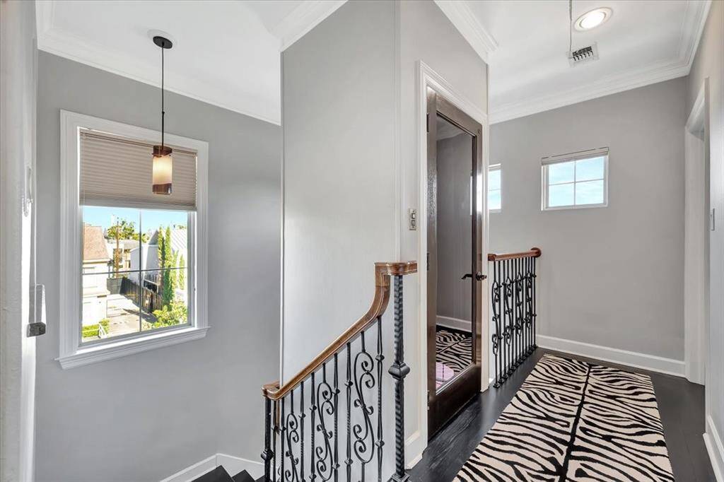 The upstairs landing show the elevator where you'll find the third bedroom, the primary suite as well as the laundry room.