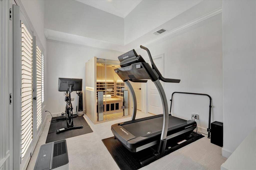 The third bedroom is currently used as a workout room with exterior balcony and attached full bath.