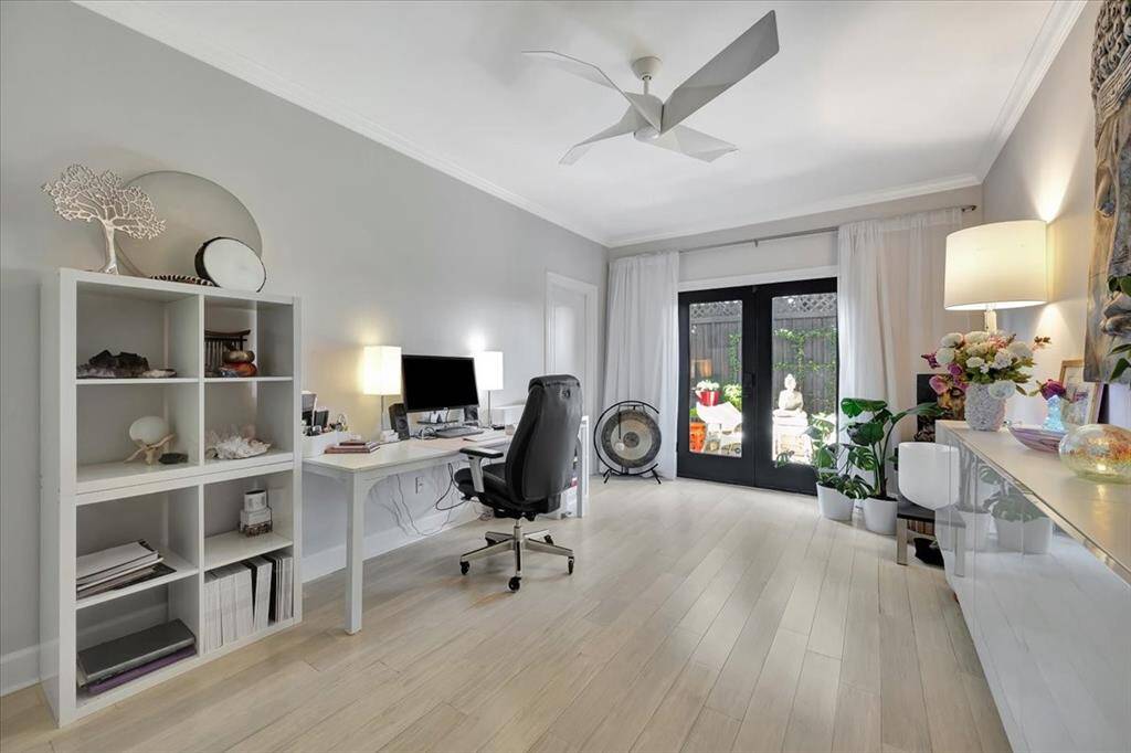 This large secondary bedroom is currently being used as a home office.  It features an en-suite, walk in closet and exterior double doors to the outdoor garden.