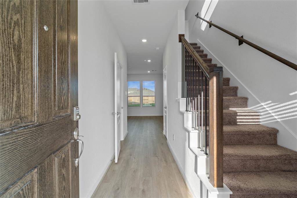 Welcome inside 2832 Shimmer Edge Drive featuring 3 bedrooms, 2 full baths and 1 half bath. This bright and welcoming entryway features Layton Lake vinyl plank flooring, neutral custom paint and recessed lighting.
