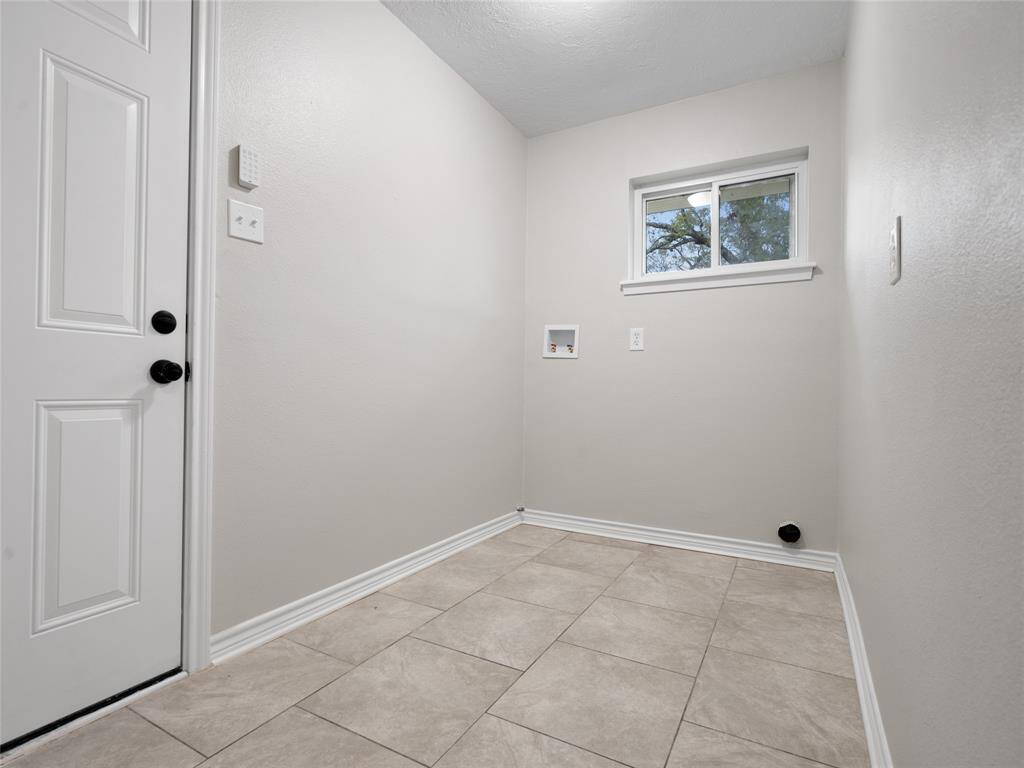 The utility room is spacious & has washer and electric dryer connections