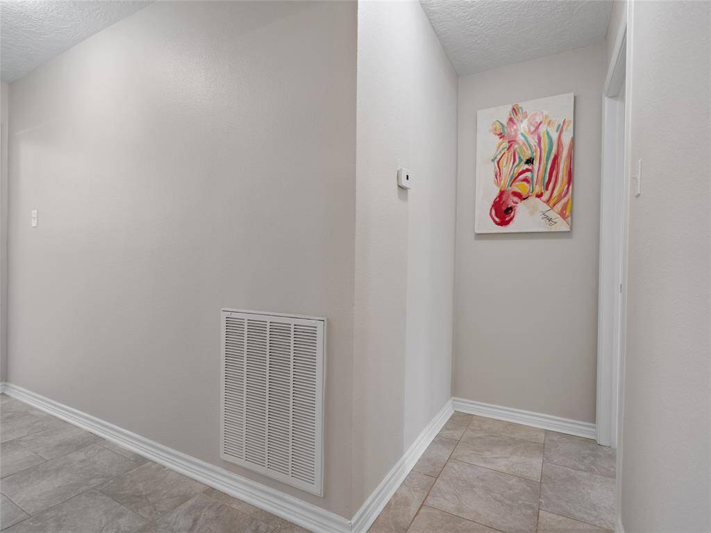 This hallway leads to the primary bedroom & a secondary bedroom on the first floor