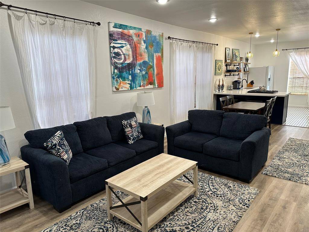 Gather the family and guests together in your lovely living room! Featuring high ceilings, recessed lighting, custom paint, gorgeous floors and large windows that provide plenty of natural lighting throughout the day.
