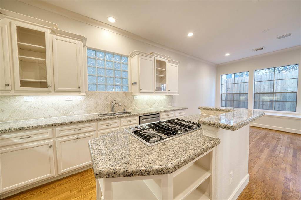 Ample counter and bar space, perfect for cooking and entertaining, seamlessly connecting to a cozy breakfast nook.