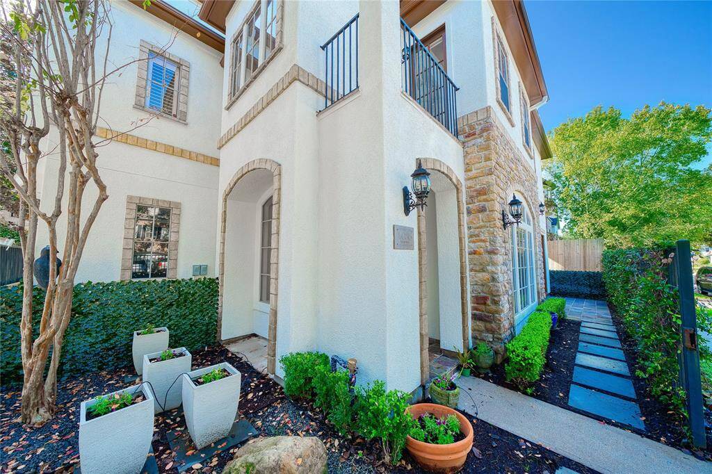 n elegant pathway guides you to the entryway, flanked by a charming garden with vibrant planters and pavers that lead seamlessly to the serene side yard, enhancing the home's inviting curb appeal.