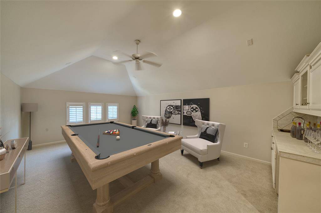 This versatile third-floor space features a wet bar and mini fridge area, perfect for entertaining or relaxation.