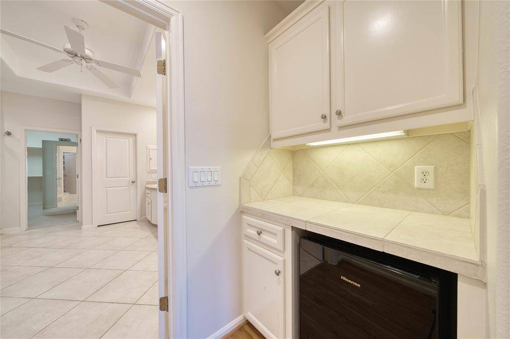 A quaint coffee bar with a mini fridge in the primary bedroom for ultimate convenience.