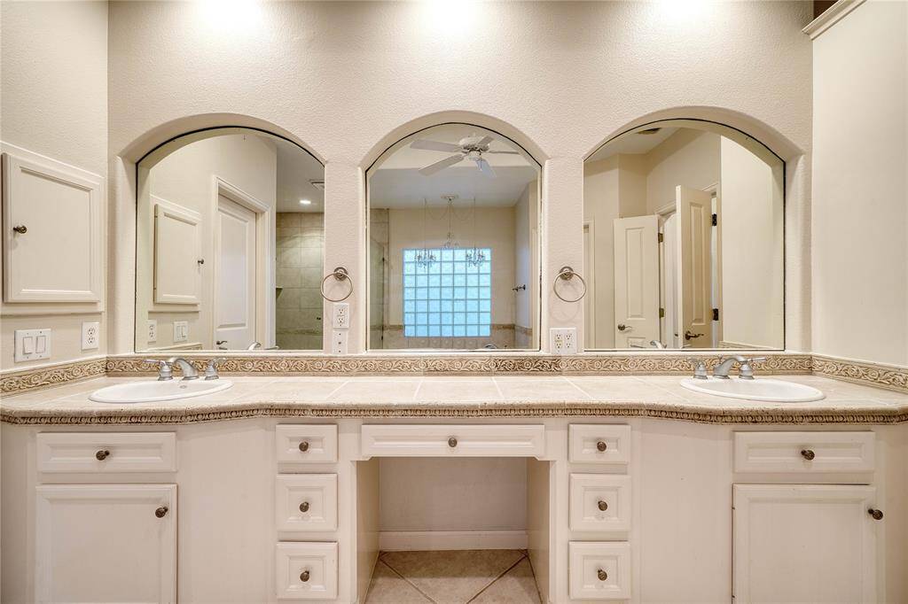 Double vanities are complimented with stylish arched mirrors.