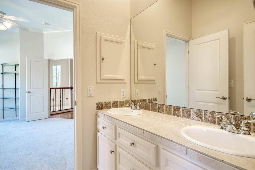 full bathroom with double vanities.