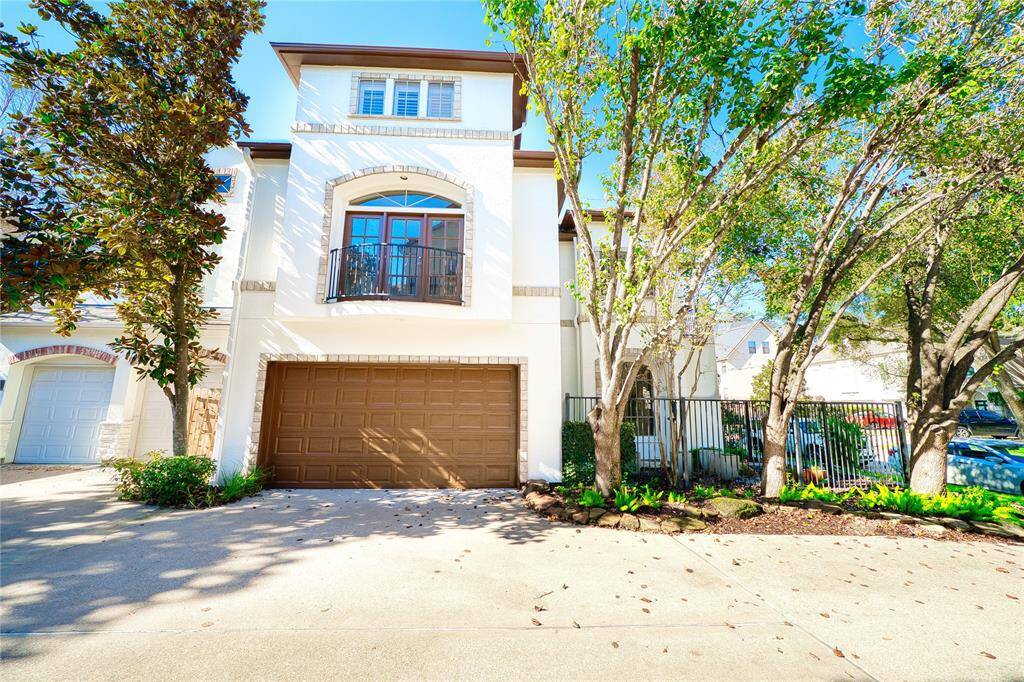 two-car garage with a newly painted door offers a fresh, modern look, while a Juliet patio with double doors from the primary bedroom provides a private, romantic retreat with stunning views.