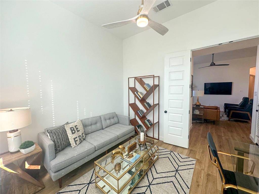 Quietly nestled in back of the home is the handsome home office. Featuring wood look luxury vinyl plank flooring, high ceilings, neutral paint and french doors.
