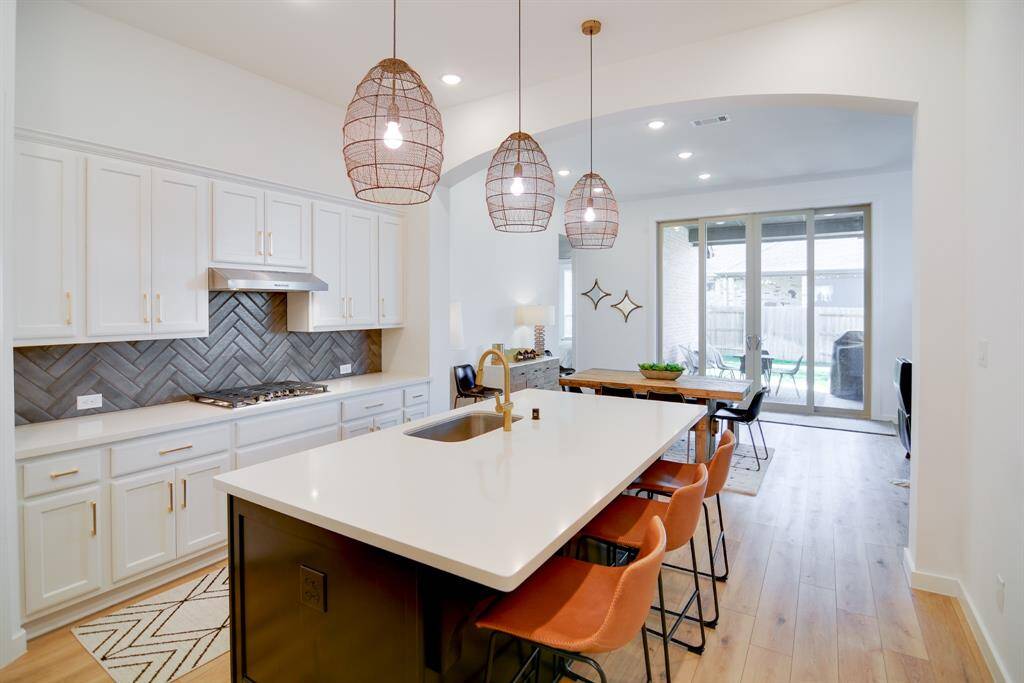 You and your guests will certainly dine in style in this amazing kitchen and dining room! Featuring large sliding glass doors that opens up to your backyard covered patio oasis, neutral paint, high ceilings and wood look luxury vinyl plank flooring. Perfect space to entertain family and friends. Enhancing the flow of indoor-outdoor living.