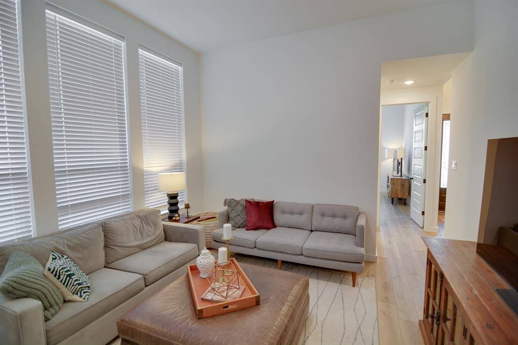 Come and enjoy a day of leisure in this fabulous game room! This is the perfect hangout spot or adult game room, this space features wood look luxury vinyl plank flooring, high ceilings, neutral paint, large windows with privacy blinds and plenty of natural light.