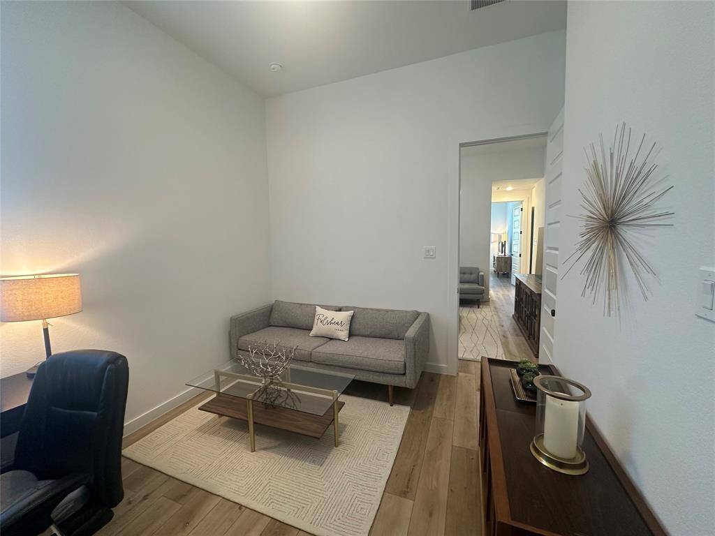 Secondary bedroom features wood look luxury vinyl plank flooring, neutral paint and plenty of space to design to your liking.