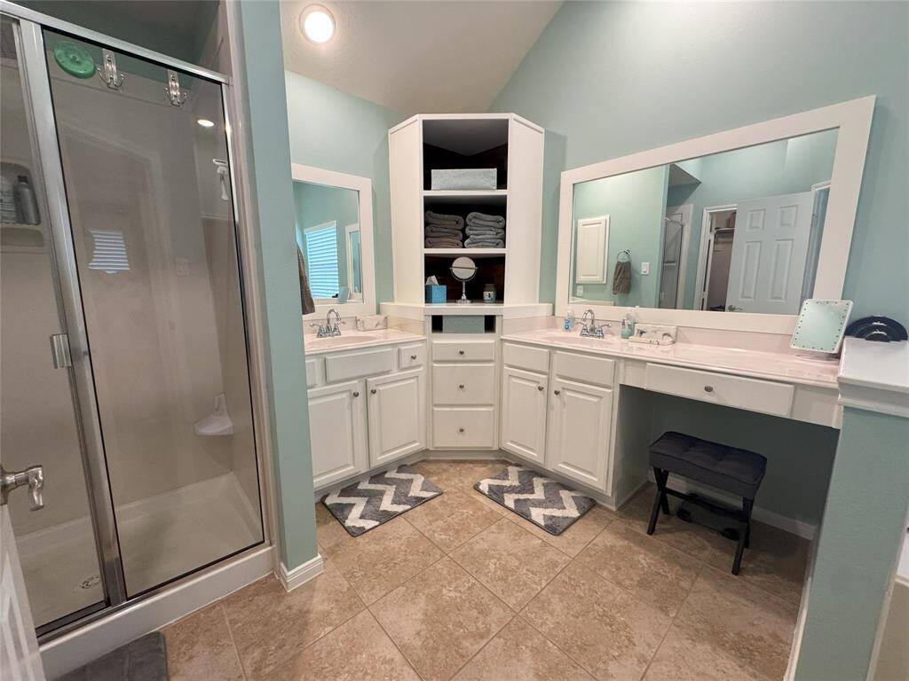 Primary bathroom with extra large shower and custom cabinets.