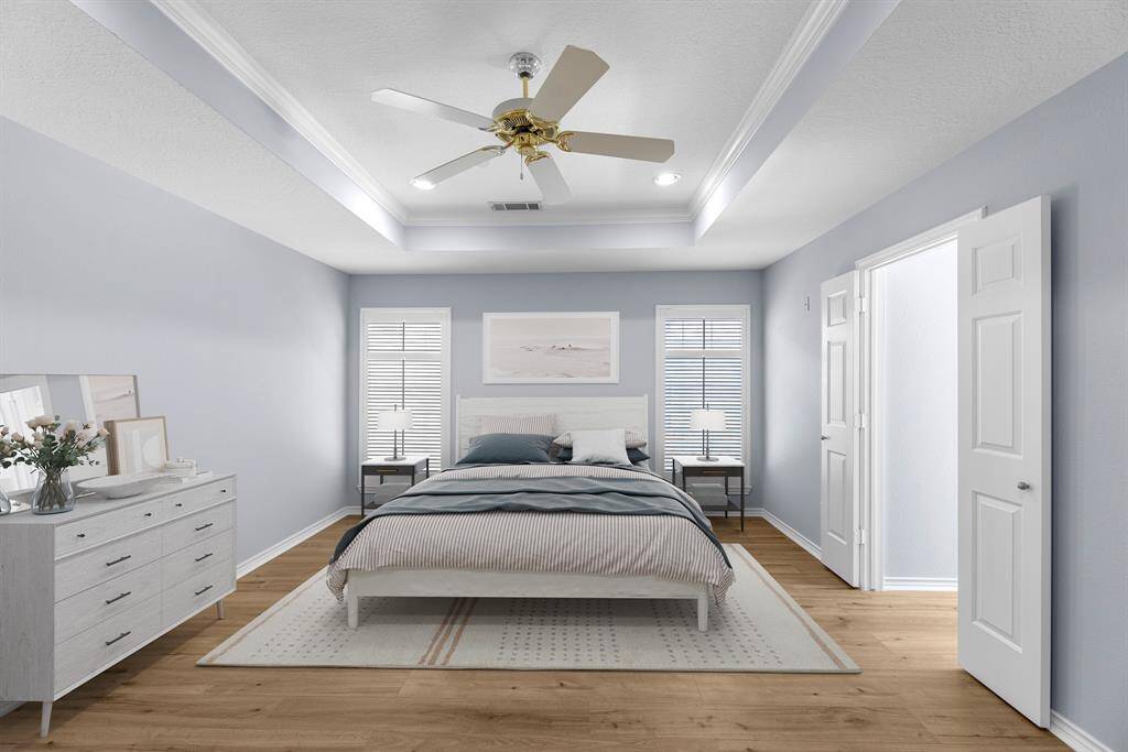 The virtually staged  primary suite is spacious enough for a king size bed and still have plenty of room for a sitting area. Notice the same classic plantation shutters which are echoed throughout all the bedrooms.