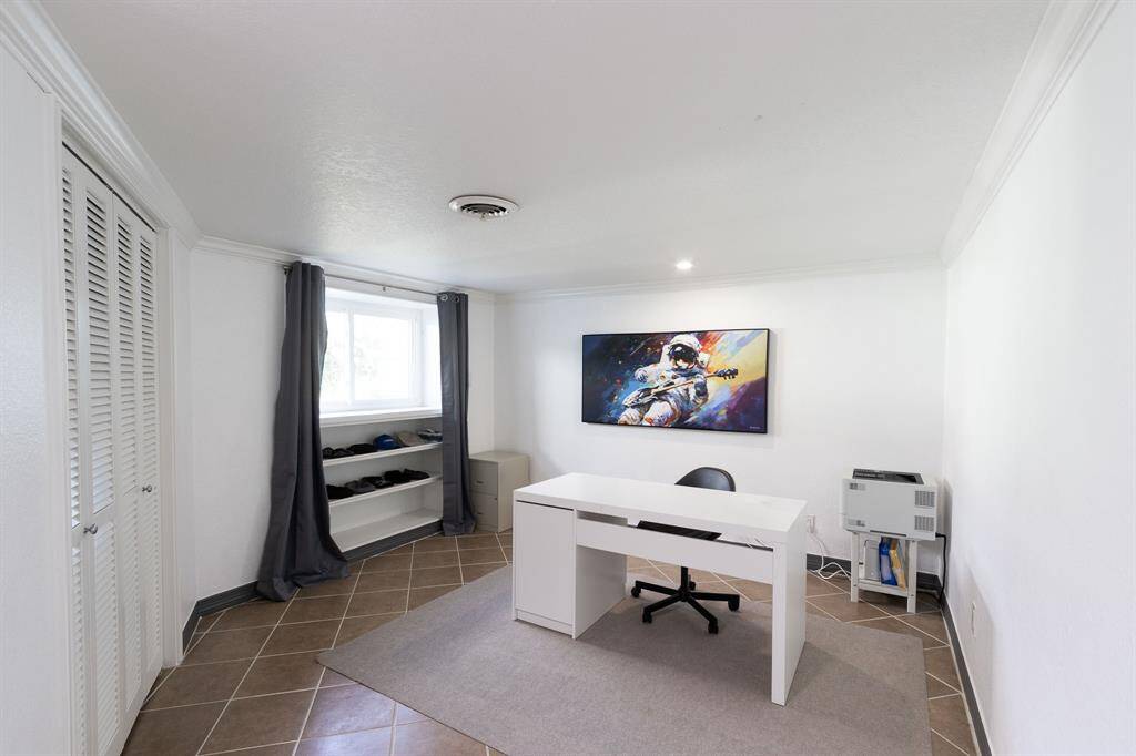 Fourth bedroom/home office looks out onto the backyard.