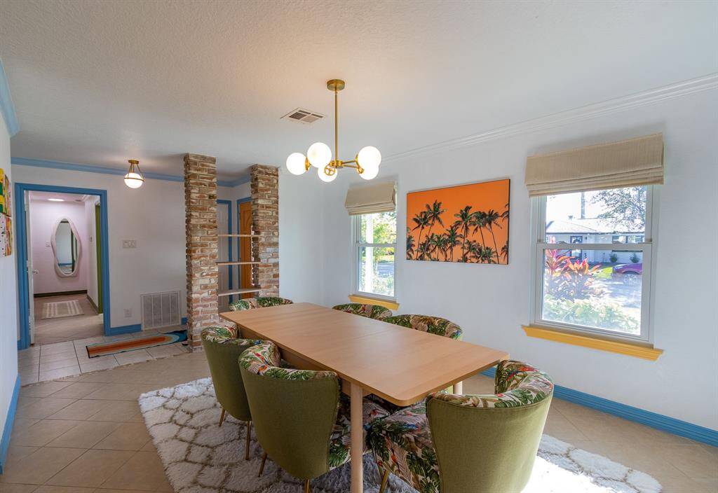 Dining room with a view of the bedroom hallway to the left.
