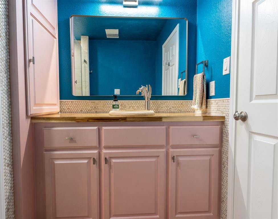 Primary bathroom with unique winged faucet.