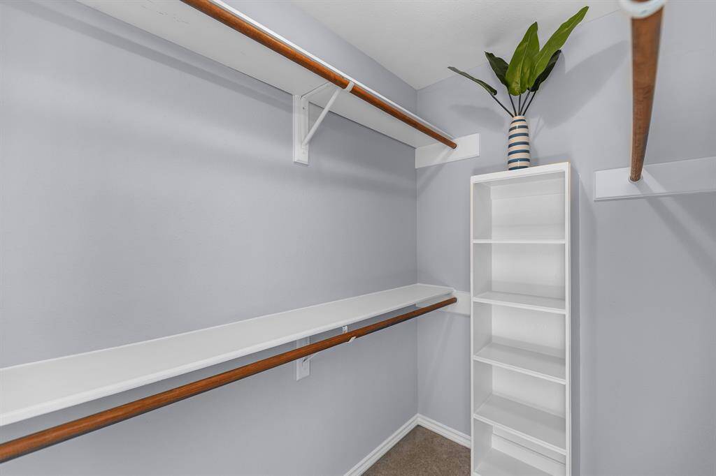 The second closet has plenty of hanging storage, as well as built-in shelving.
