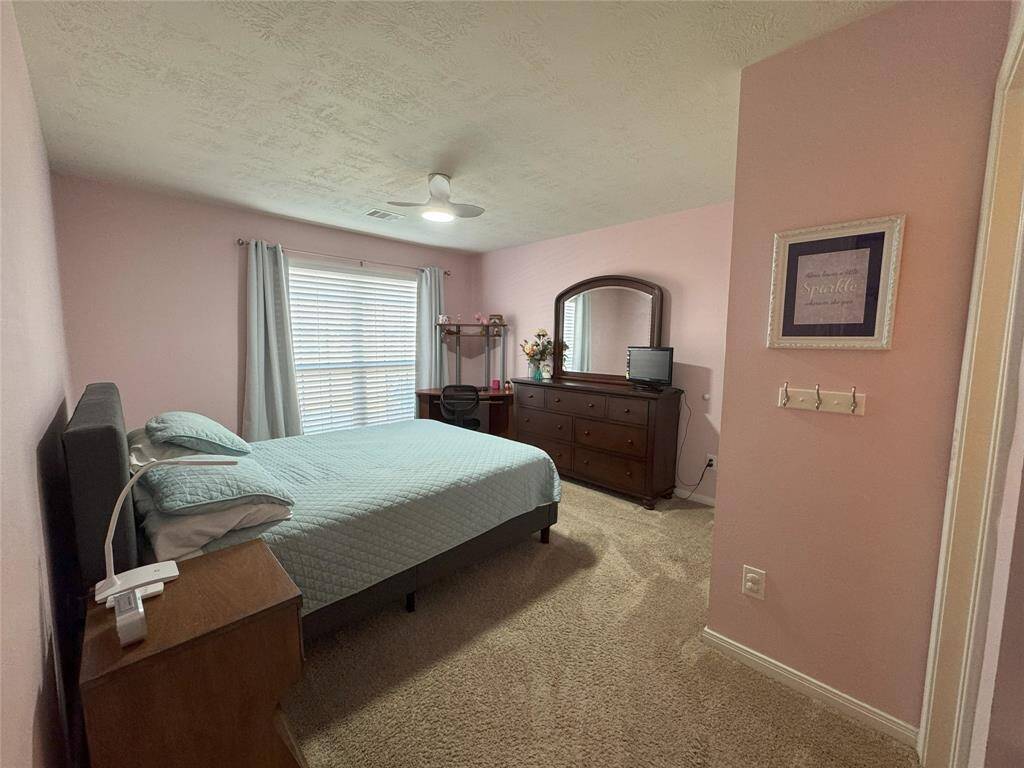 Fourth bedroom with ceiling fan and large closet.