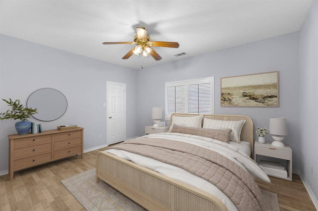 The virtually staged secondary bedroom has classic plantation shutters and a substantial sized walk-in closet.