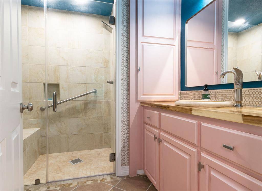 Primary bathroom with large shower with bench.