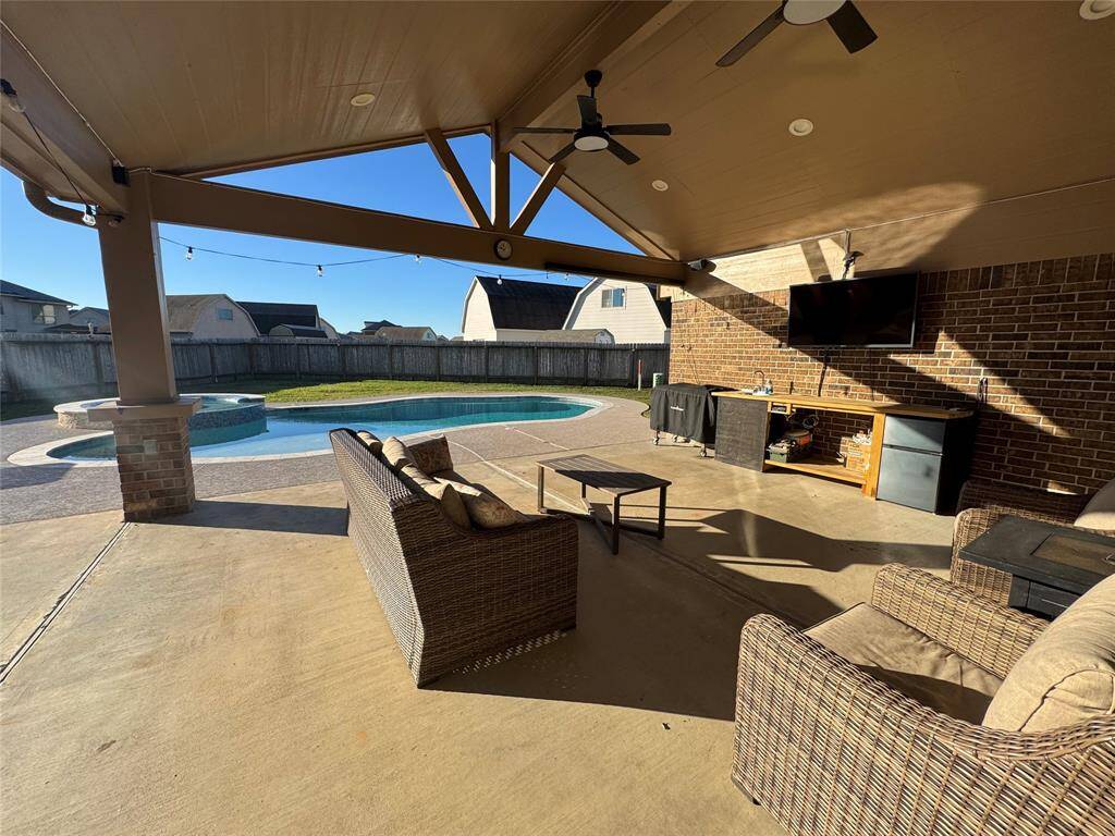 Large custom patio with lights and ceiling fans.