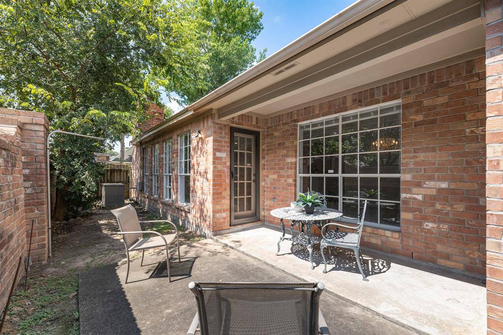 The backyard provides a grea place for morning coffee, after dinner drinks, or al-fresco dining when the weather is cooler. The solid brick wall adds privacy and comes with a bird feeder.