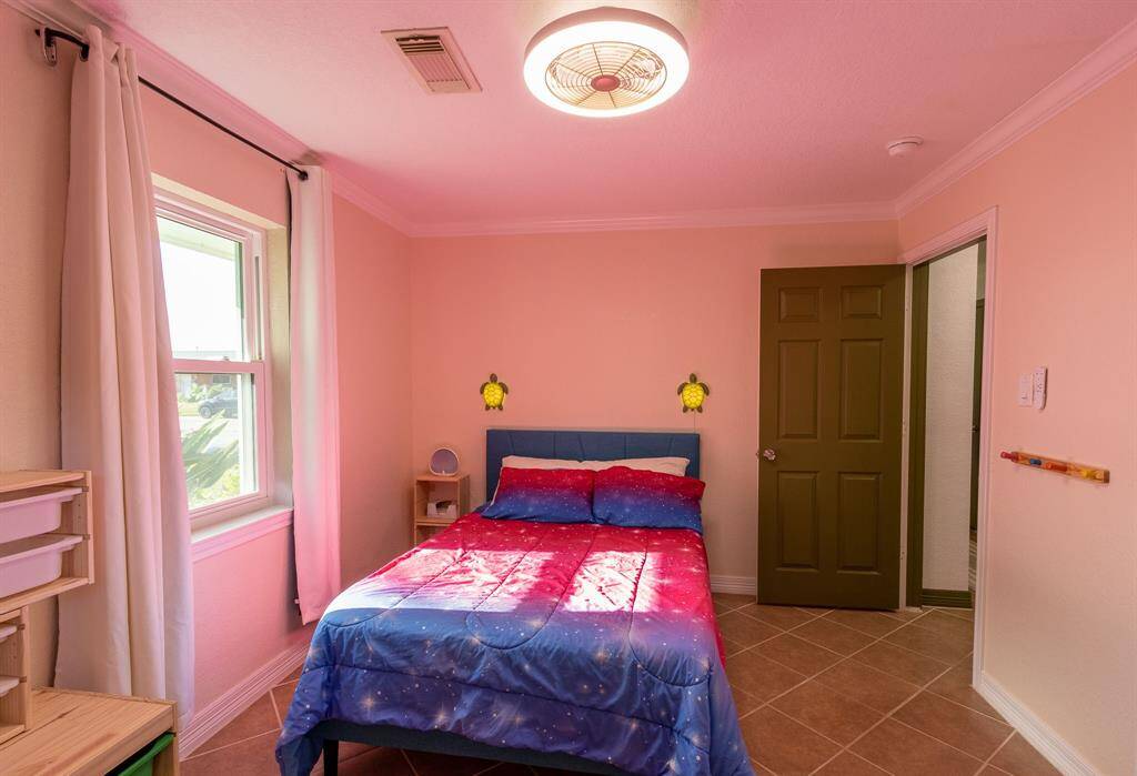 Second front bedroom. Turtle lamps on either side of the bed and the shelving are exempt from sale.
