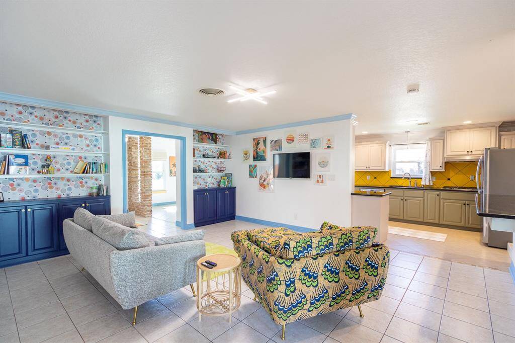 Looking through the living room with the kitchen to the right and the dining room in the background to the left.