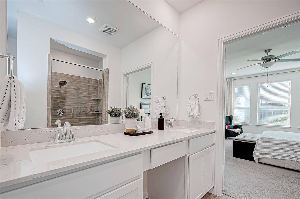The primary bathroom features dual sinks.