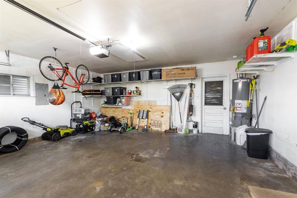 Two car garage with backdoor to the backyard and koi pond.