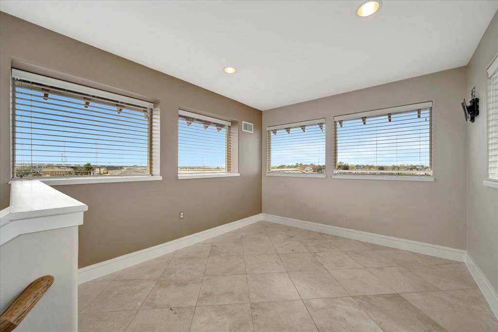 A spacious primary closet with built-in drawers, ample room for hanging clothes, and a customized shoe rack, offering both organization and functionality.