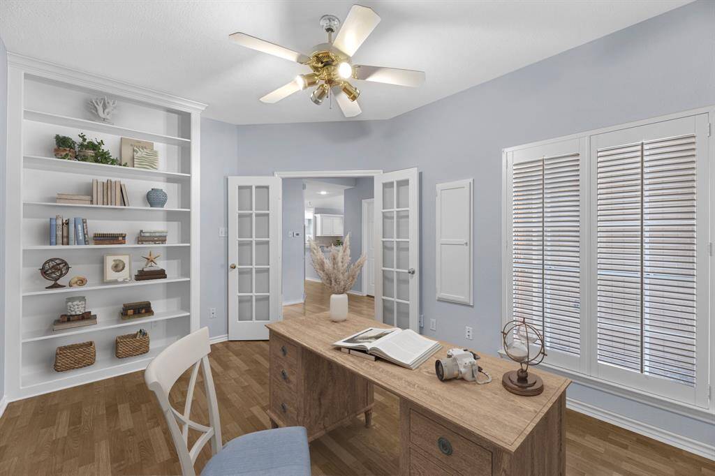 Office, or secondary bedroom, is just off the entrance. It is virtually staged as an office, but can be used as a secondary bedroom. It has a large closet and sophisticated plantation shutters.