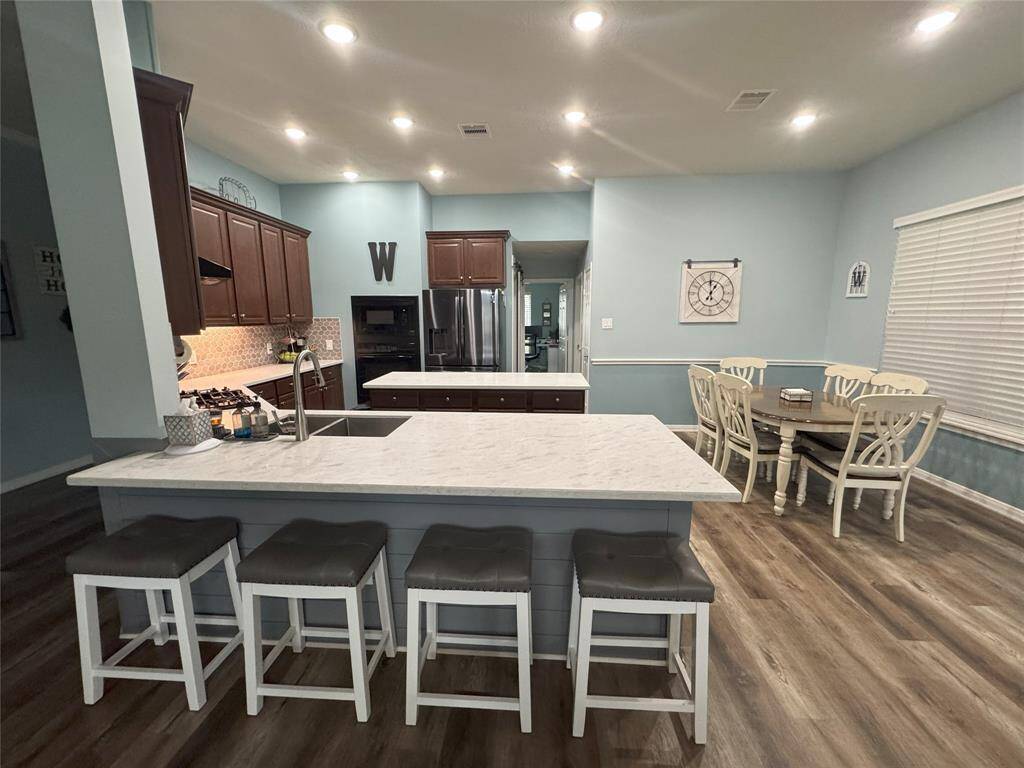 Kitchen and dining with upgraded quartz countertops.