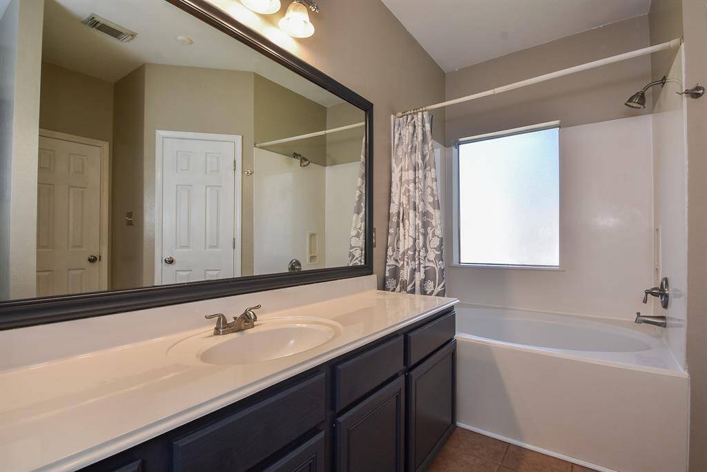 Primary bath features large vanity, decorative mirror and garden tub!