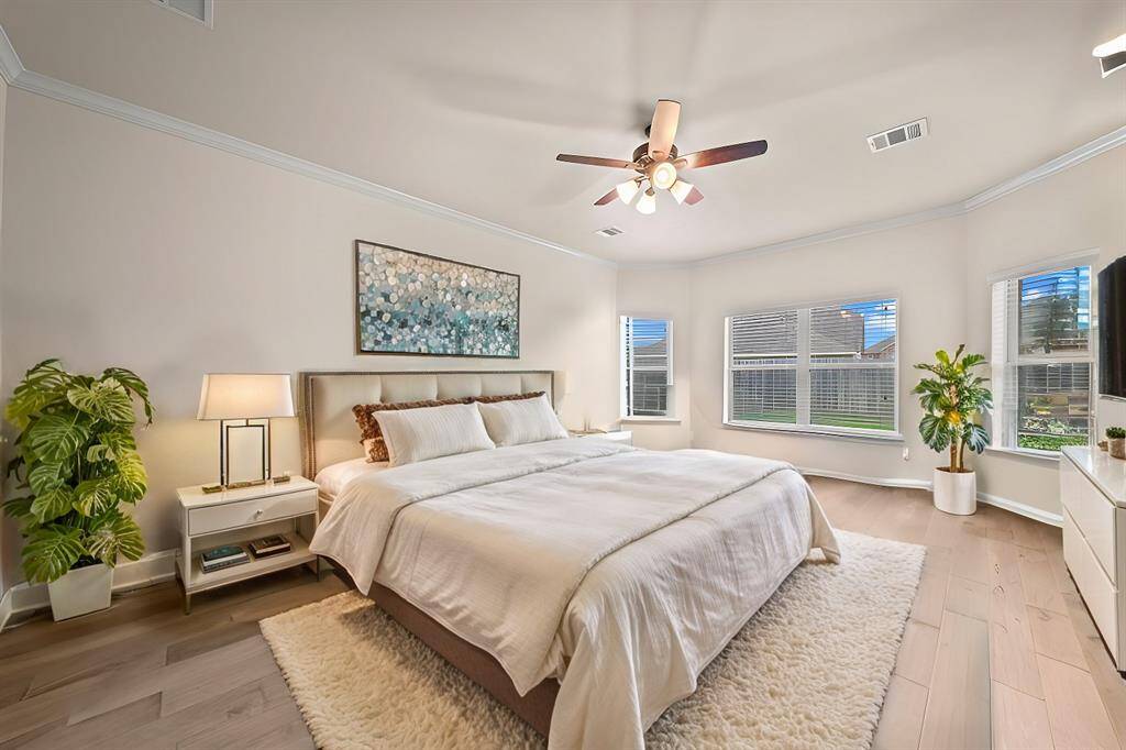 Master suite is privately located downstairs with views of the backyard. (Virtually staged)