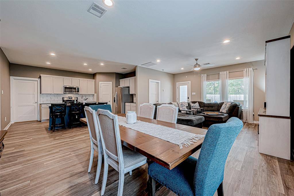 Open-concept dining, kitchen, and family room with modern finishes and abundant natural light.