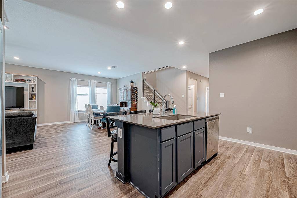 Bright, open view from the kitchen to the inviting dining area and staircase.
