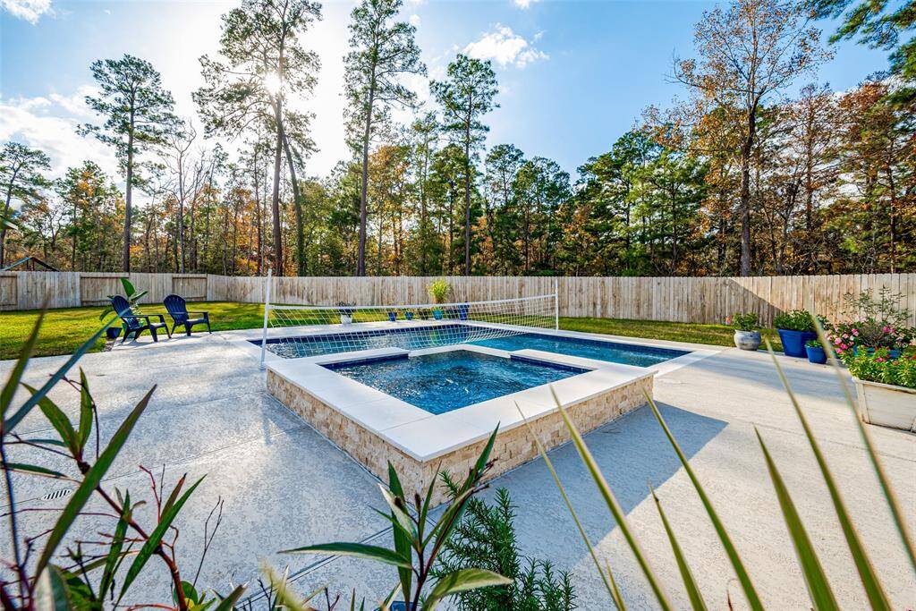 Enjoy serene views of lush trees and open sky from your private pool deck, with no neighbors or possible new construction behind you.