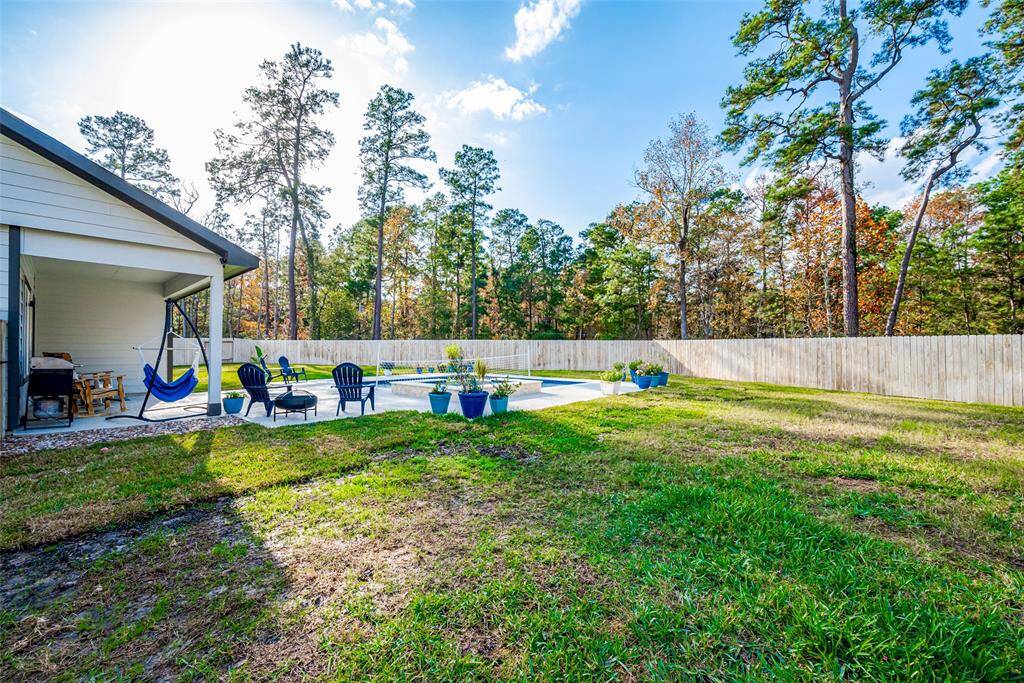 Expansive backyard with ample space surrounding the pool, perfect for outdoor activities and relaxation.